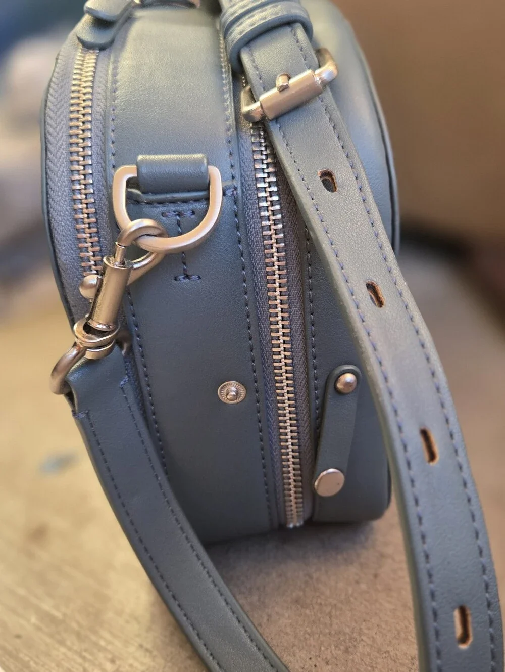 This is a TWELVElittle x The Sensible Mama Clutch in a muted blue vegan leather.